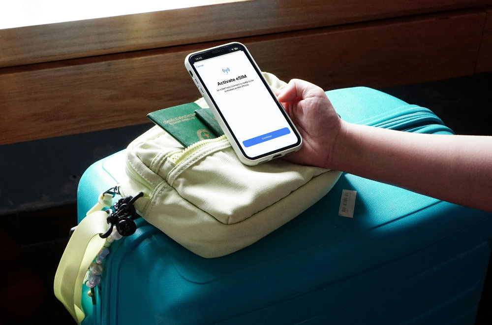 Person holding phone with eSIM setup